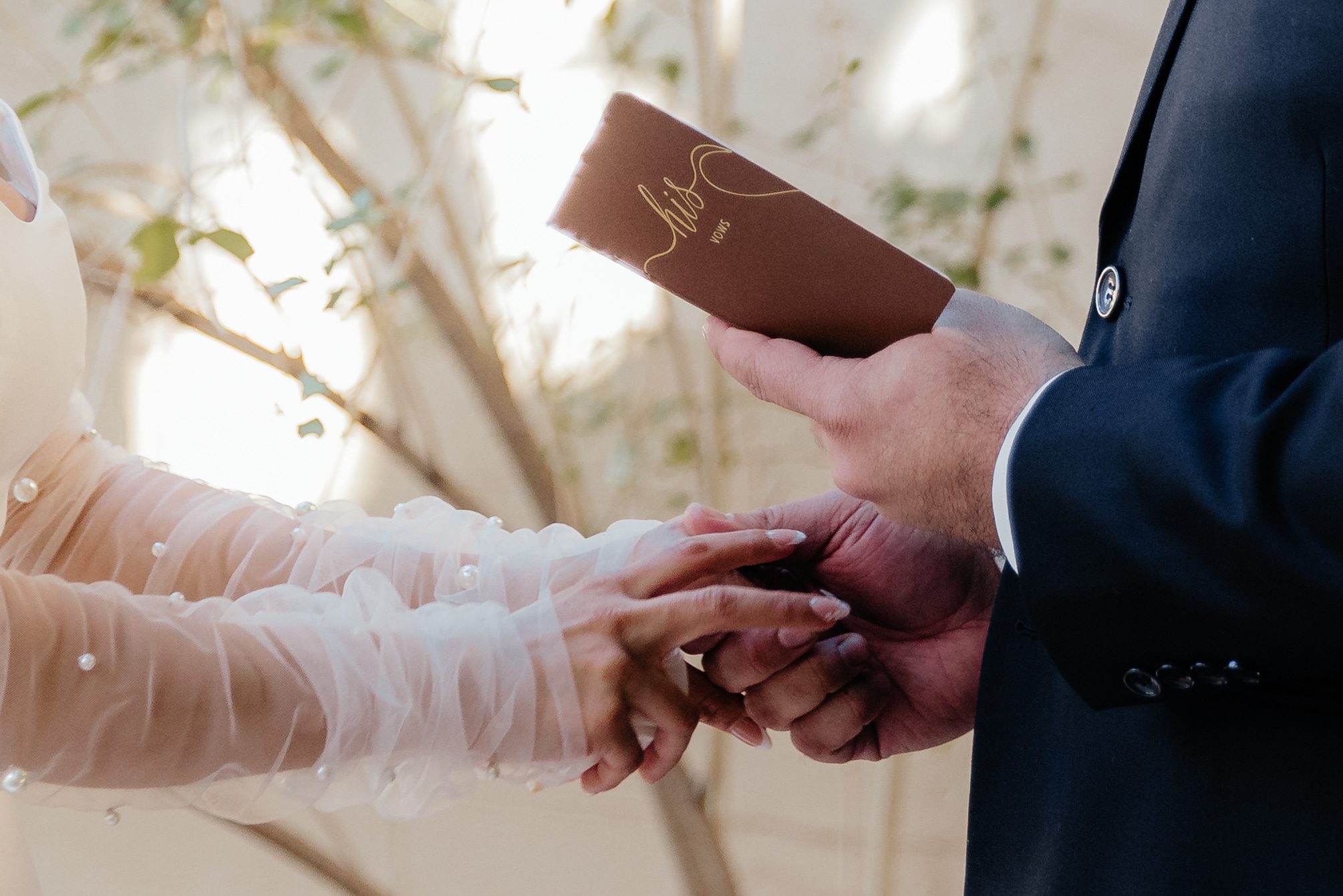 Couple holding hands during private vow taken by wedding photographer in Phoenix at Arizona wedding.